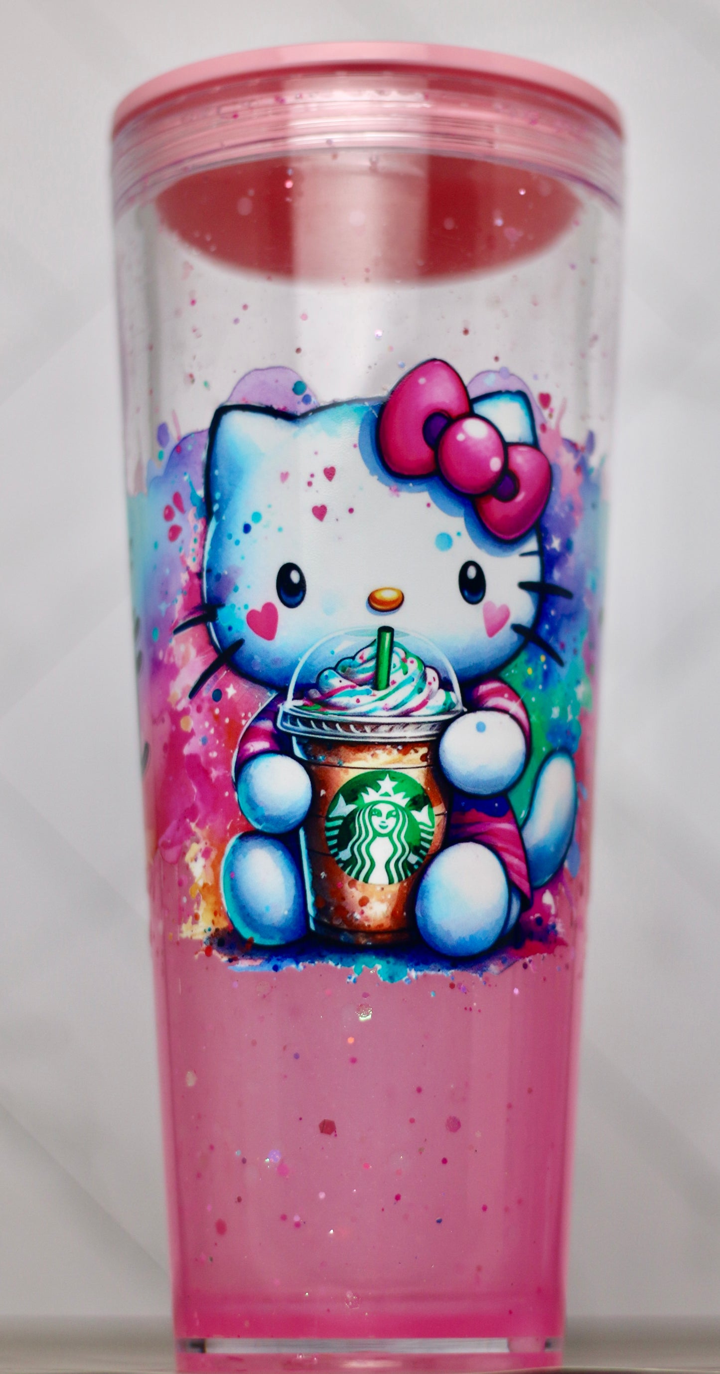 Handmade Hello Kitty snow globe tumbler with pink glitter and reusable straw